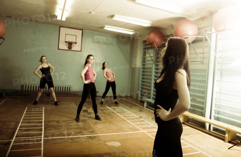 Caucasian dancers rehearsing in gym