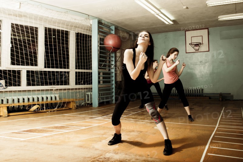 Caucasian dancers rehearsing in gym