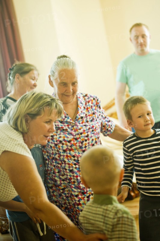 Caucasian multi-generation family relaxing indoors