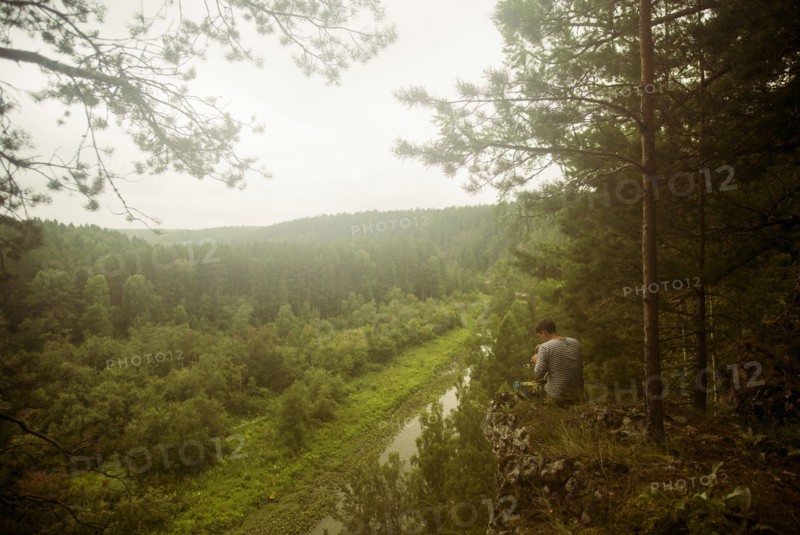 Caucasian man admiring scenic view from rural hilltop