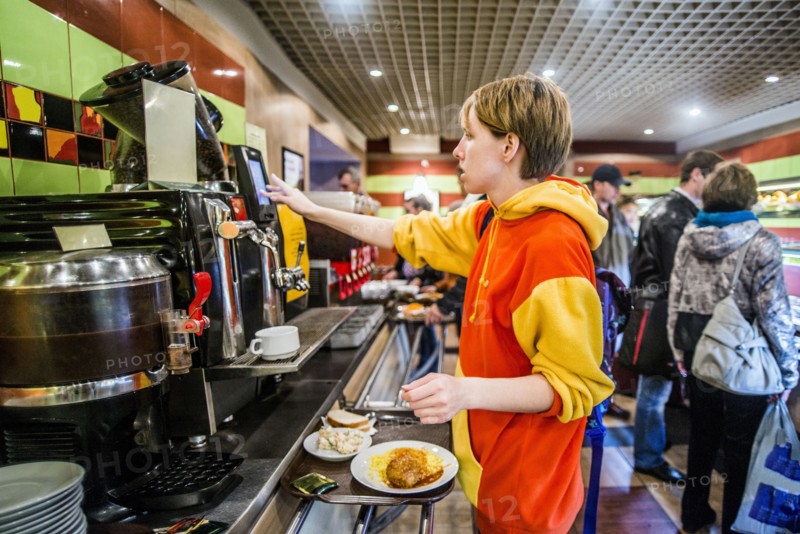Caucasian woman getting breakfast in cafeteria