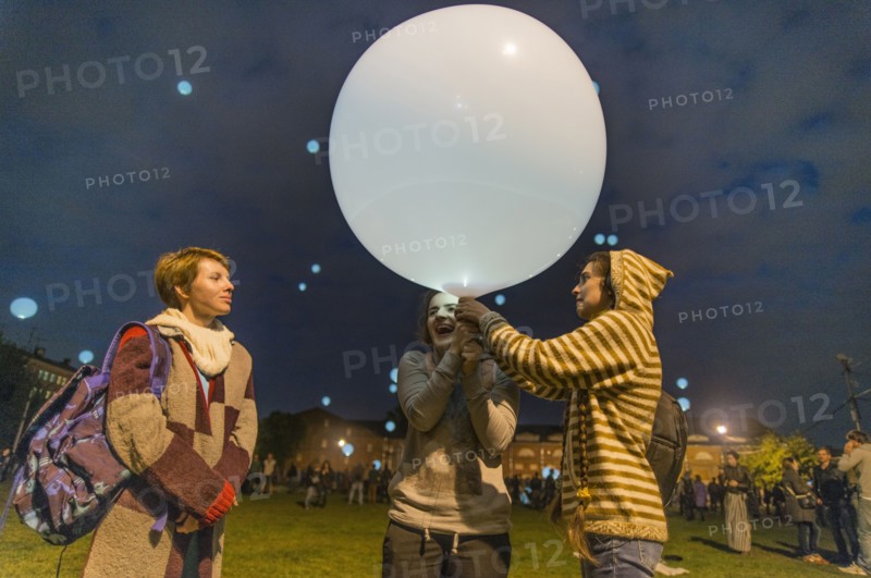 Caucasian friends playing with balloon in park
