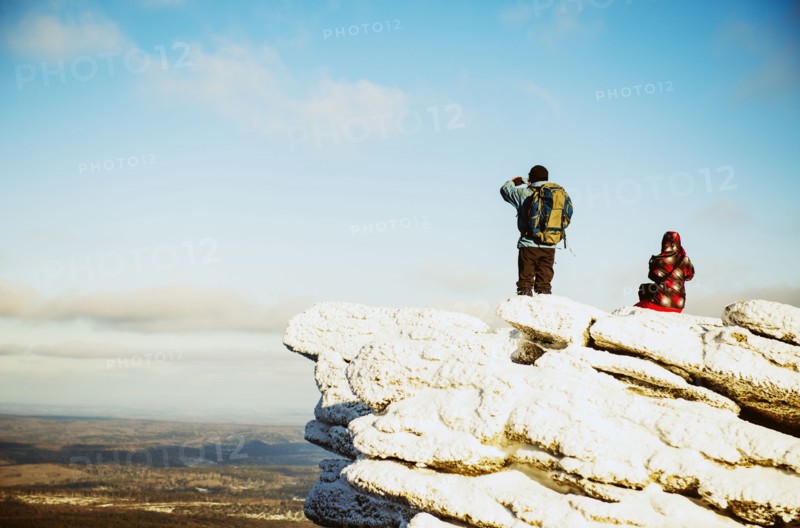 Caucasian hikers admiring scenic view from mountaintop