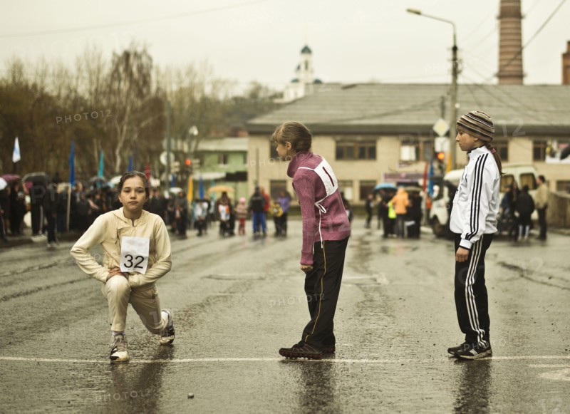 Caucasian children preparing for race on street