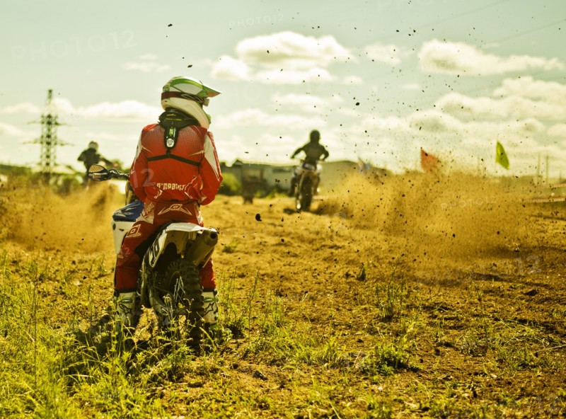 Caucasian motocross biker waiting on race course