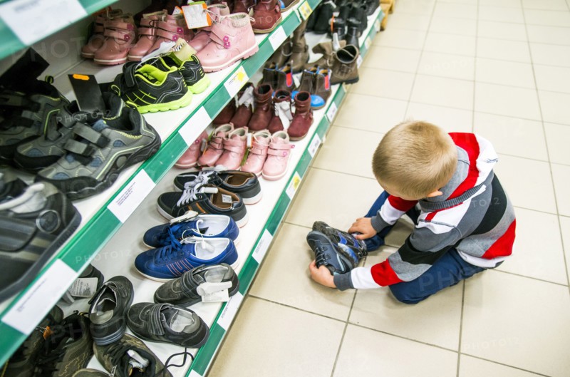 Caucasian boy shopping in shoe store