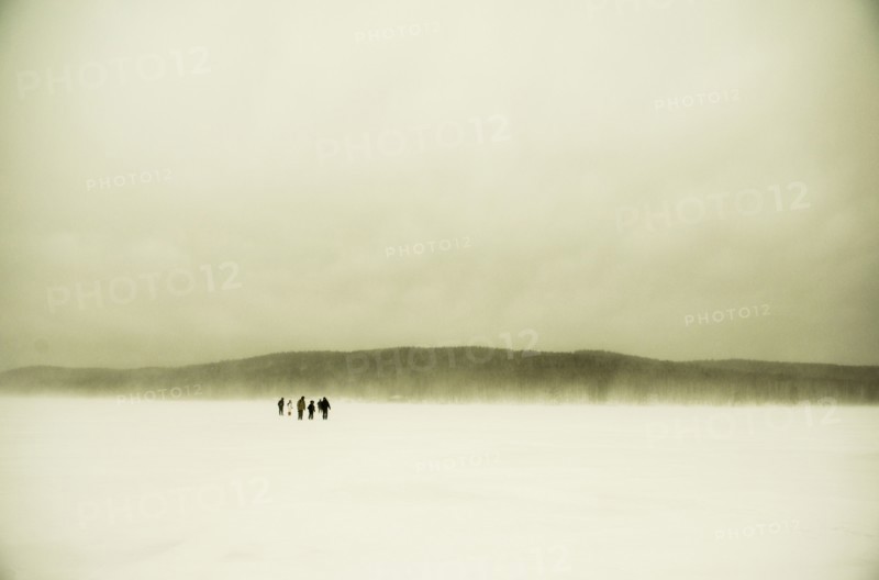 Caucasian hikers walking in snowy remote field