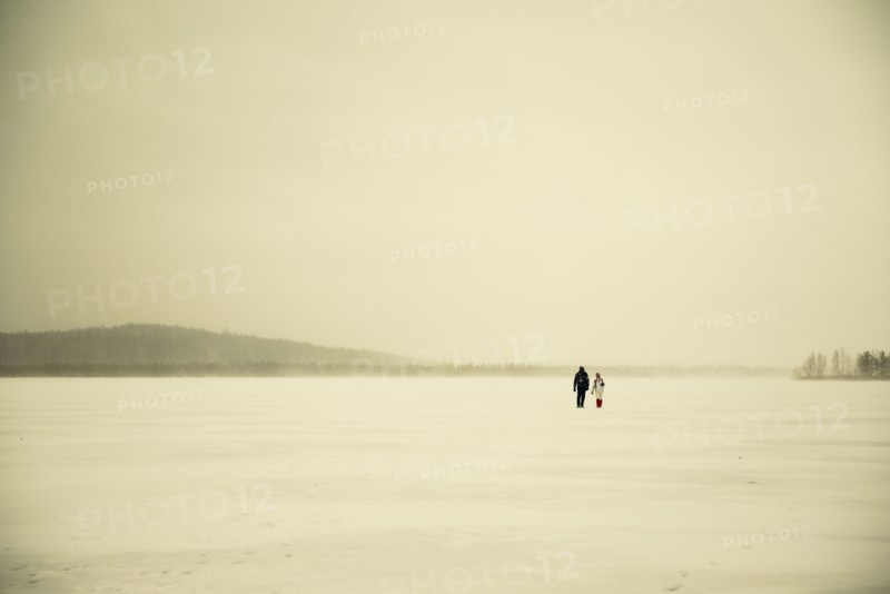 Caucasian hikers walking in snowy remote field