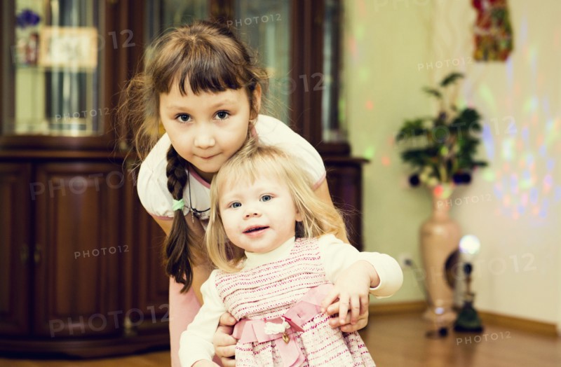 Caucasian sisters playing in house