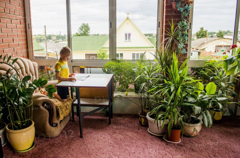 Caucasian boy reading magazine at desk