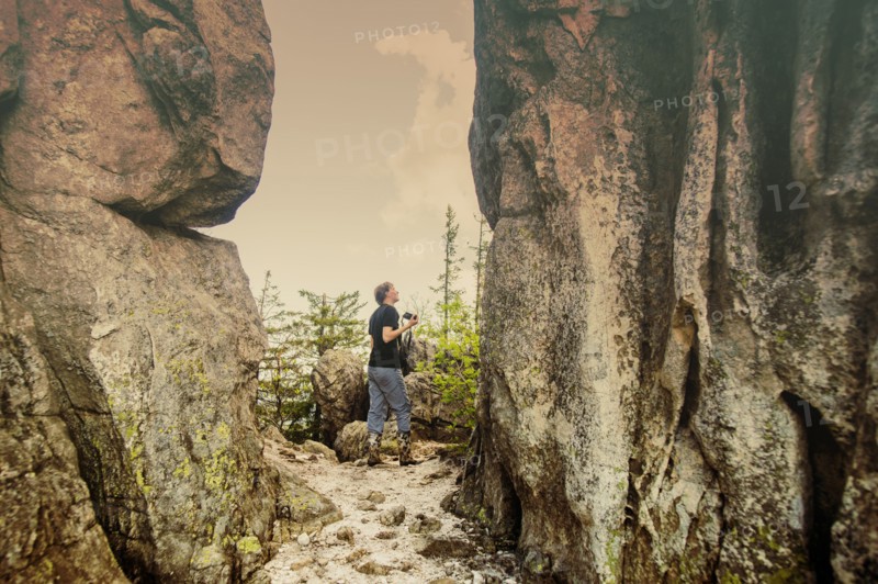 Caucasian hiker walking by remote cliffs