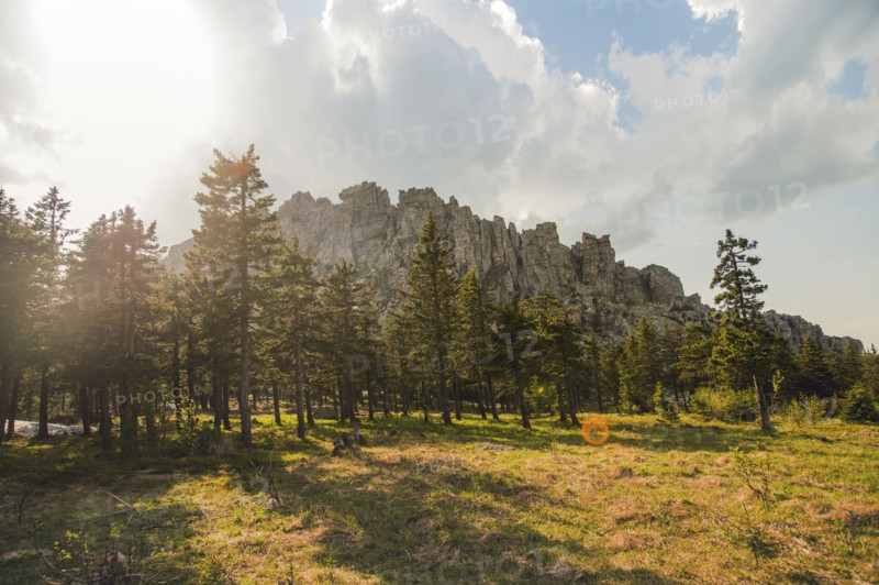 Rocky hilltop over forest in remote field