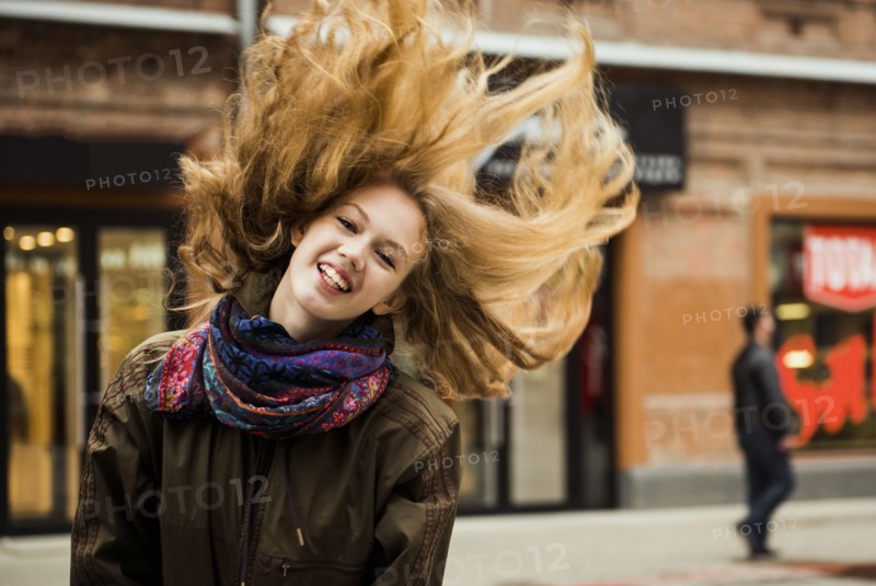 Caucasian woman tossing hair outdoors