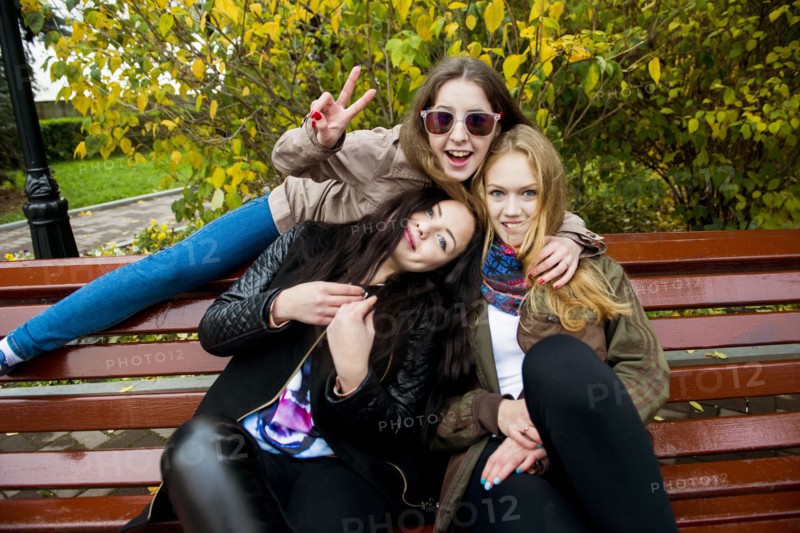 Caucasian women posing on bench