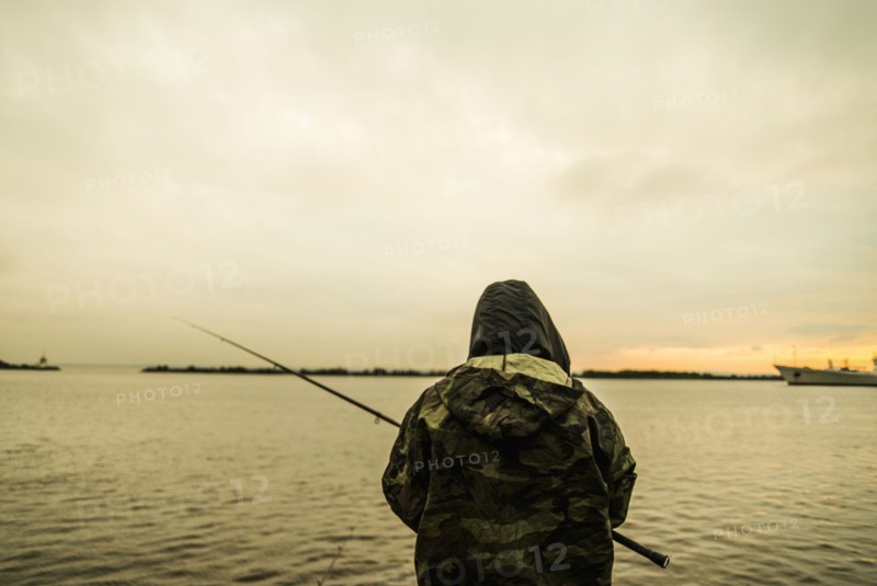 Caucasian man fishing in remote lake