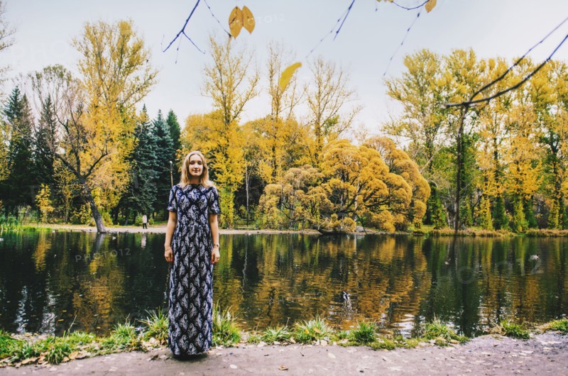 Caucasian woman smiling near pond in park