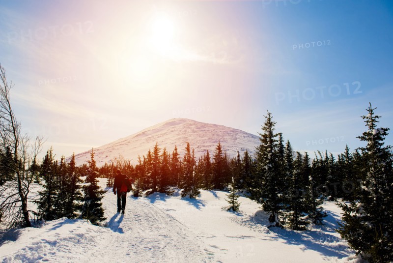 Man hiking on mountain in winter