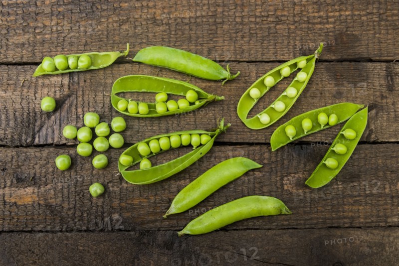 Fresh peas on wooden table