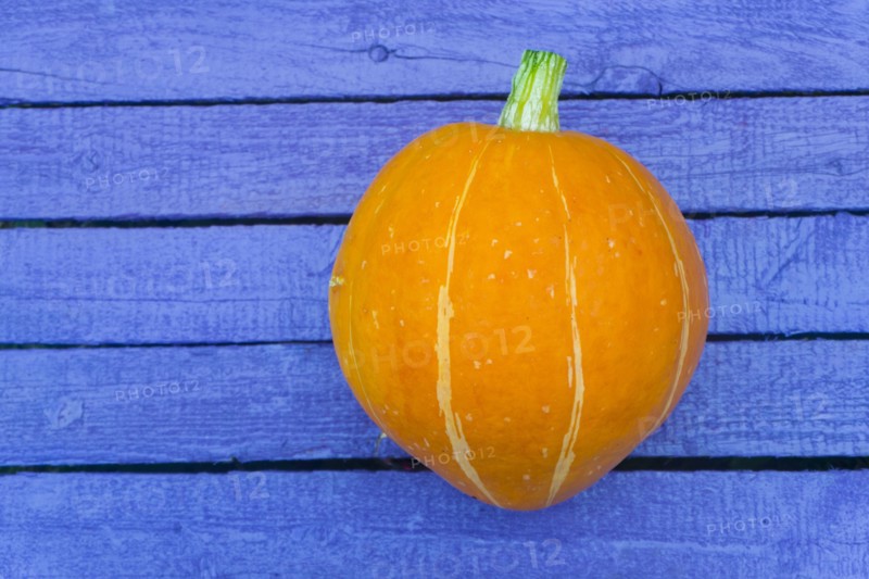 Pumpkin on purple wooden table