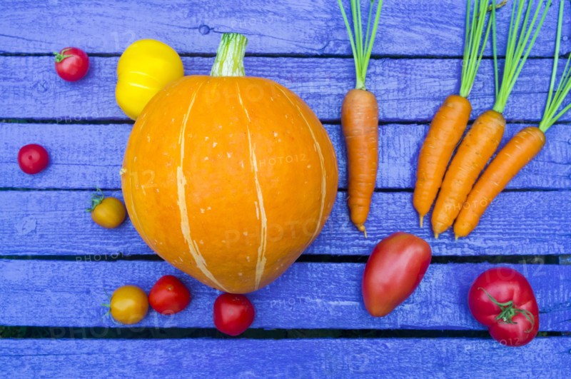 Fresh vegetables on purple wooden table
