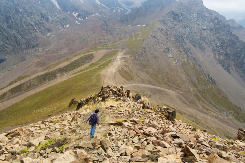 Caucasian man hiking on mountain rocks