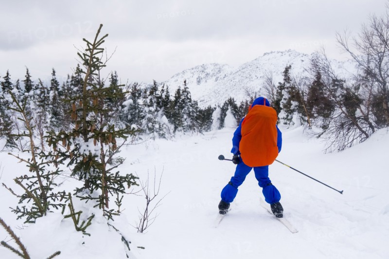 Caucasian man cross-country skiing near mountain