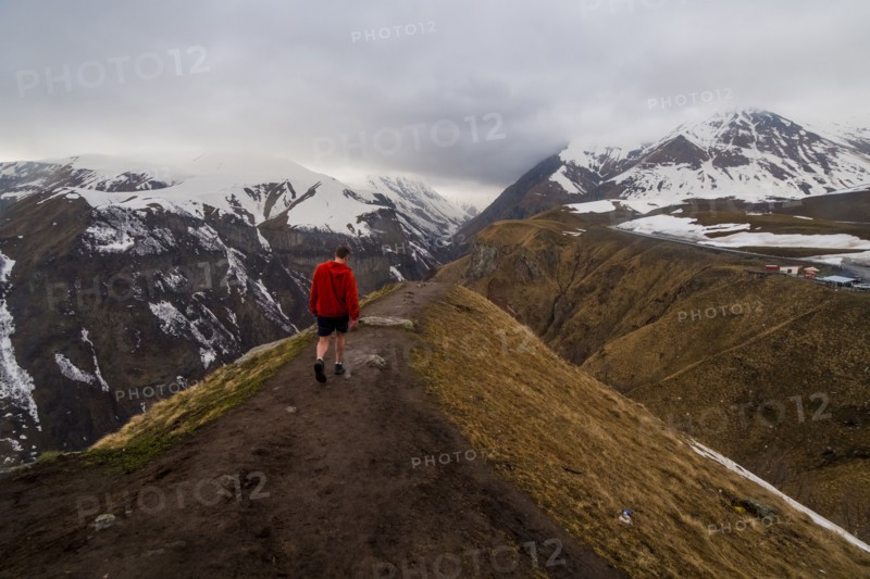 Caucasian man hiking on snowy Mountain