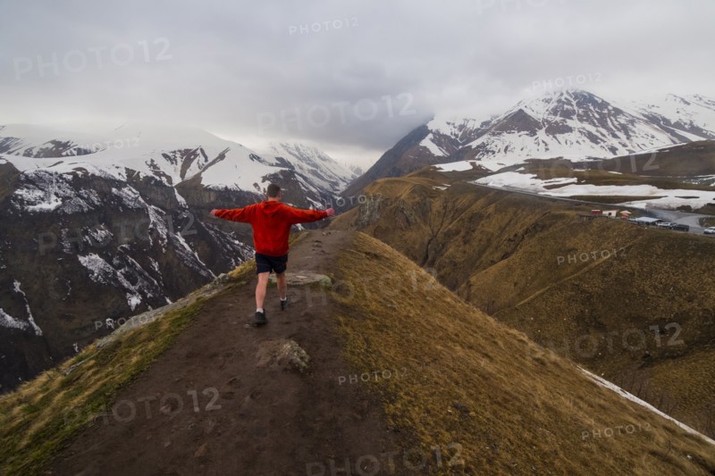 Caucasian man hiking on snowy Mountain