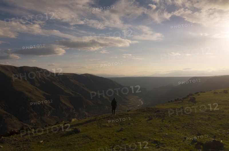 Distant Caucasian man admiring scenic view of valley