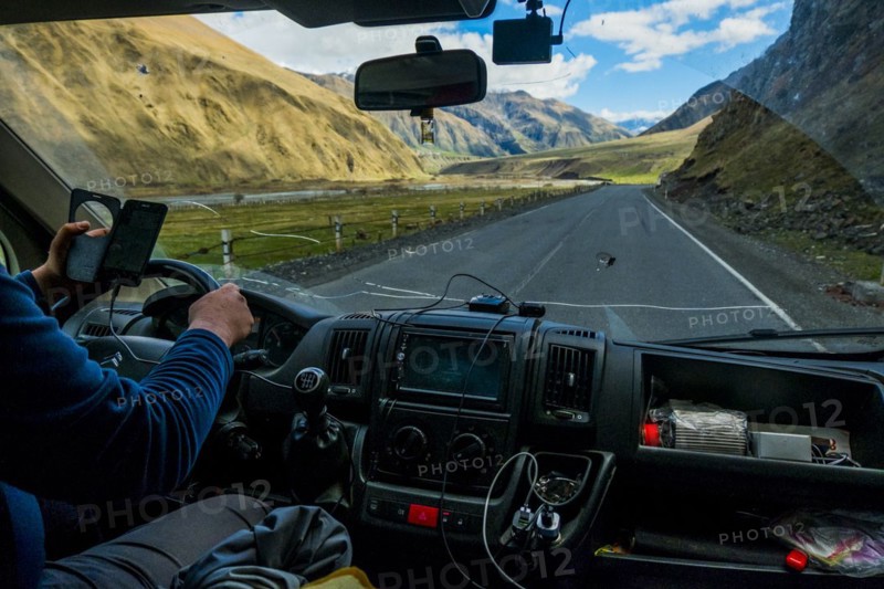 Caucasian man driving car while using cell phone
