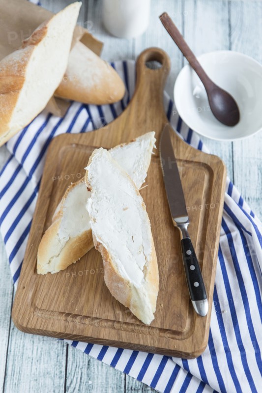 Bread with butter on cutting board