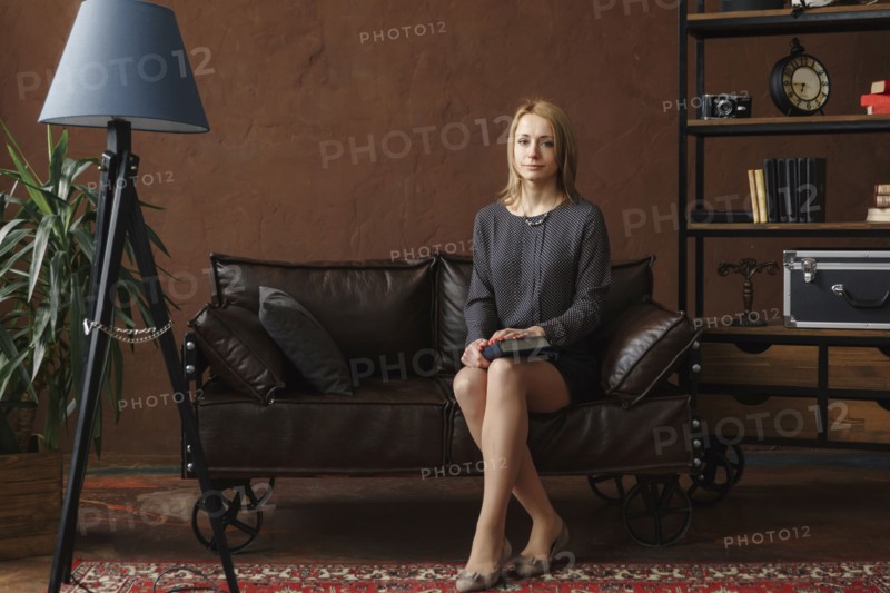Portrait of Middle Eastern woman sitting on sofa