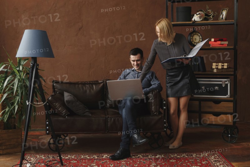 Middle Eastern couple using laptop in livingroom