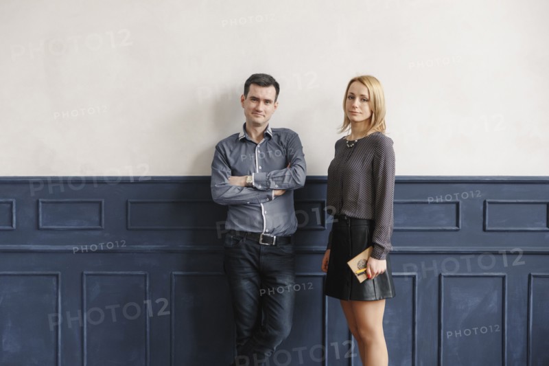 Portrait of Middle Eastern couple standing near wall