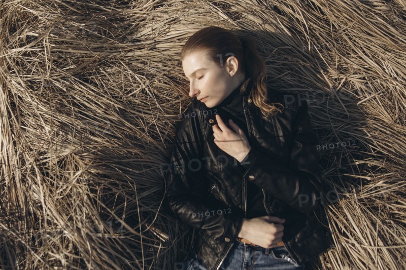 Middle Eastern woman resting in tall grass