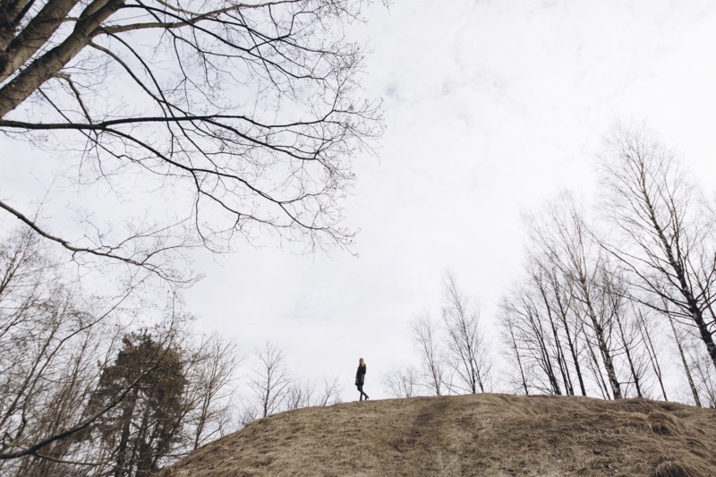 Distant woman standing on hill