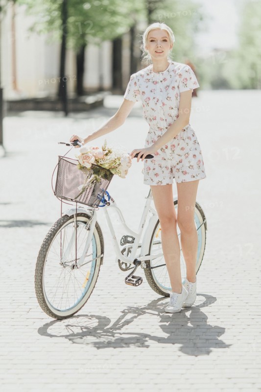 Portrait of Middle Eastern woman standing near bicycle