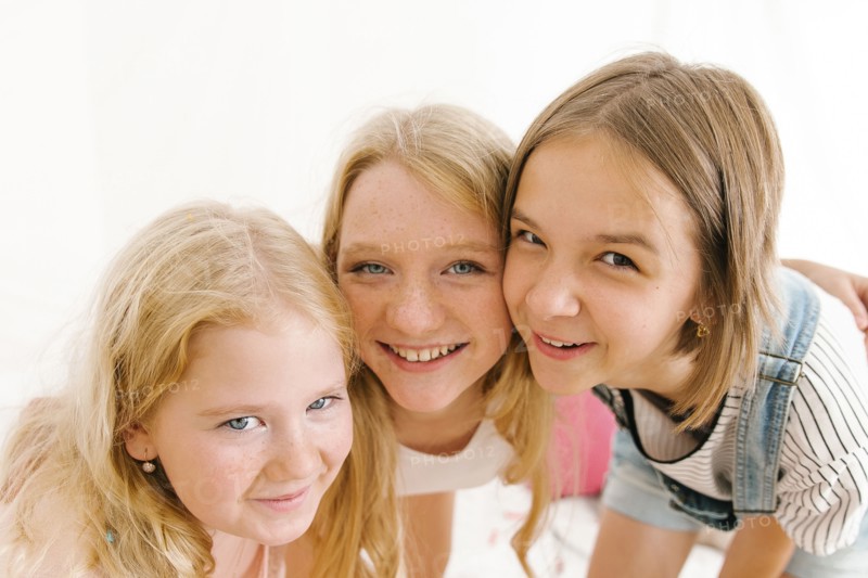 Portrait of smiling Middle Eastern sisters cheek to cheek