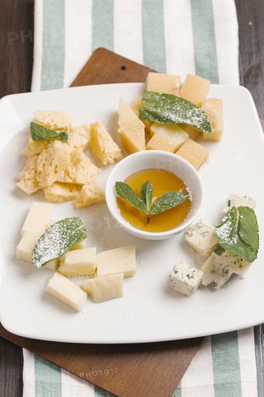 Variety of cheeses on plate with sauce