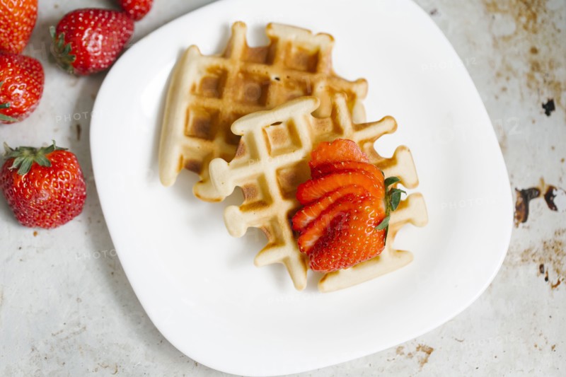 Sliced strawberries on waffles