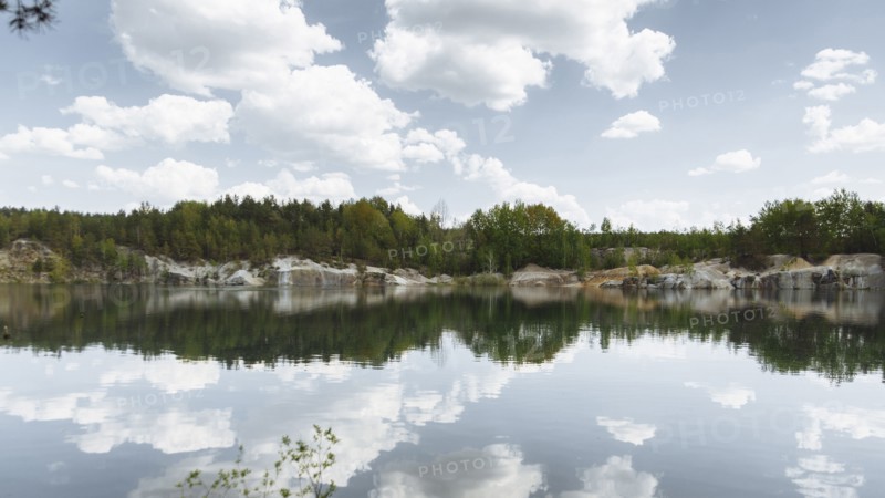 Reflection of clouds in still lake