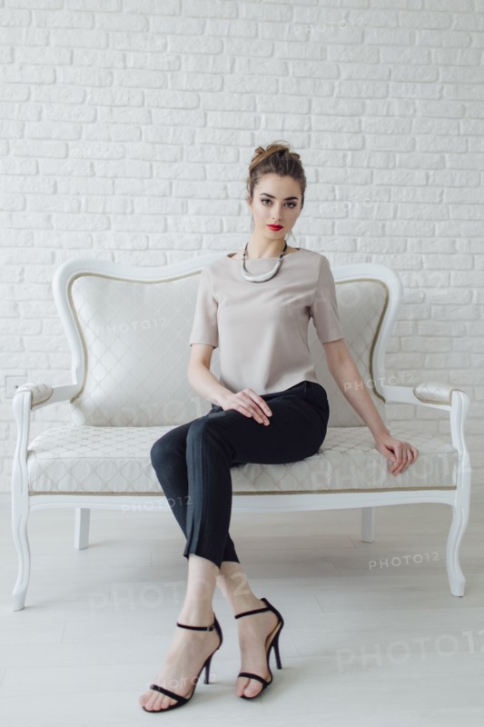 Portrait of glamorous Middle Eastern woman sitting on bench