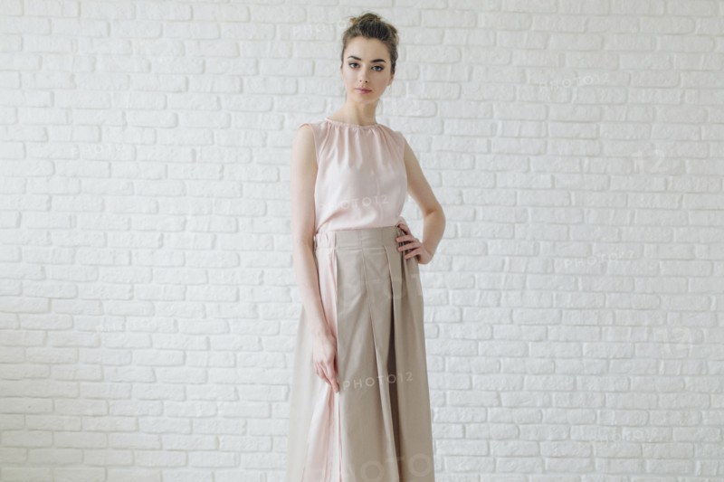 Portrait of glamorous Middle Eastern woman standing near wall