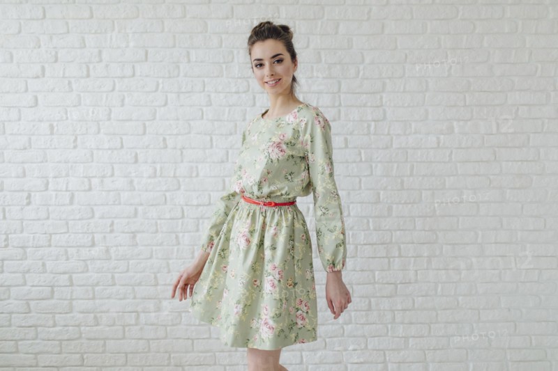 Portrait of glamorous Middle Eastern woman standing near wall