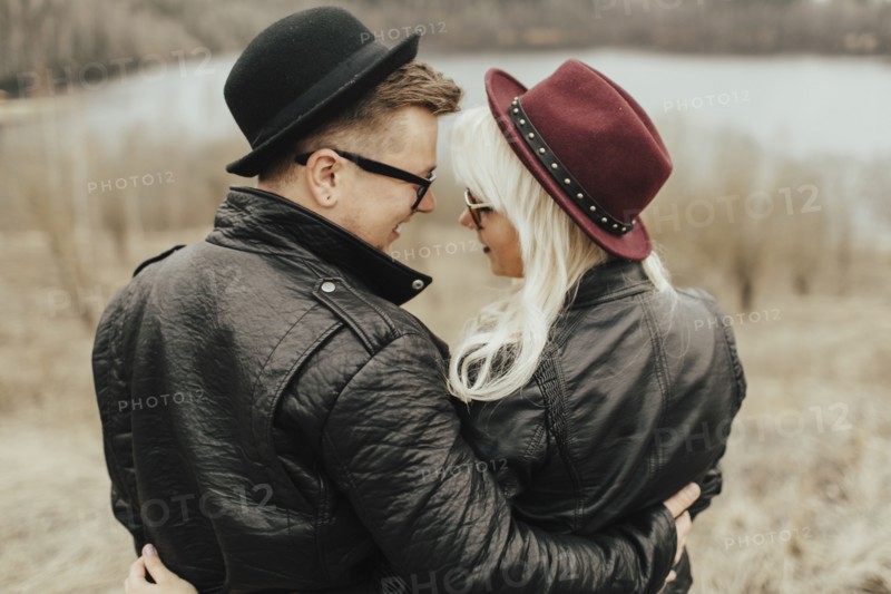 Middle Eastern couple hugging near lake