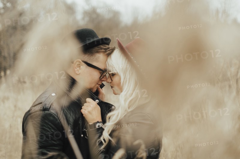 Middle Eastern couple rubbing noses in field