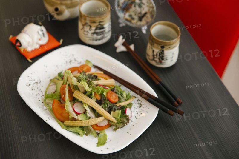 Chopsticks on the plate of salad