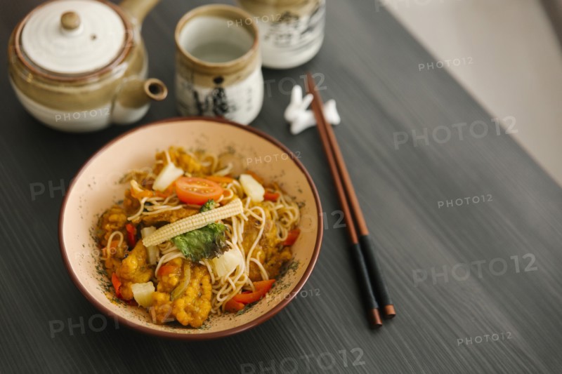 Chopsticks near bowl of food