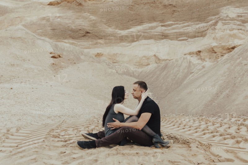 Middle Eastern couple cuddling in desert