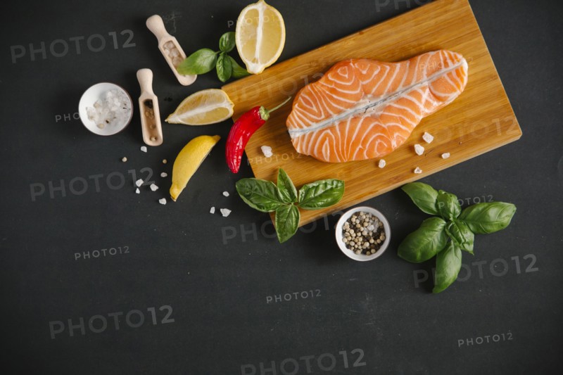 Raw salmon on cutting board with ingredients
